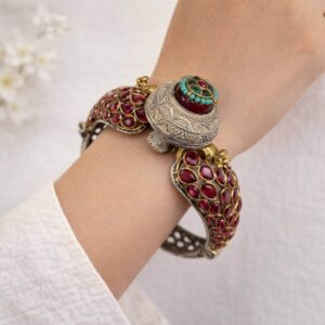 Model wear Heavy silver and gold kada with ruby stones and turquoise beads.