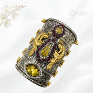 Two silver bangles with teardrop pink enamel stones.