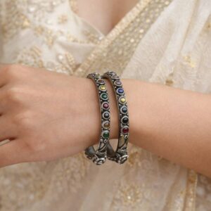 Two German silver bangles with colorful stones.