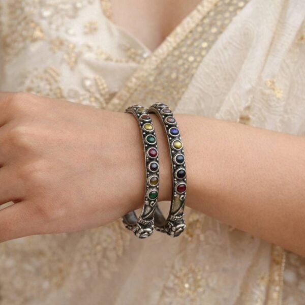 Two German silver bangles with colorful stones.