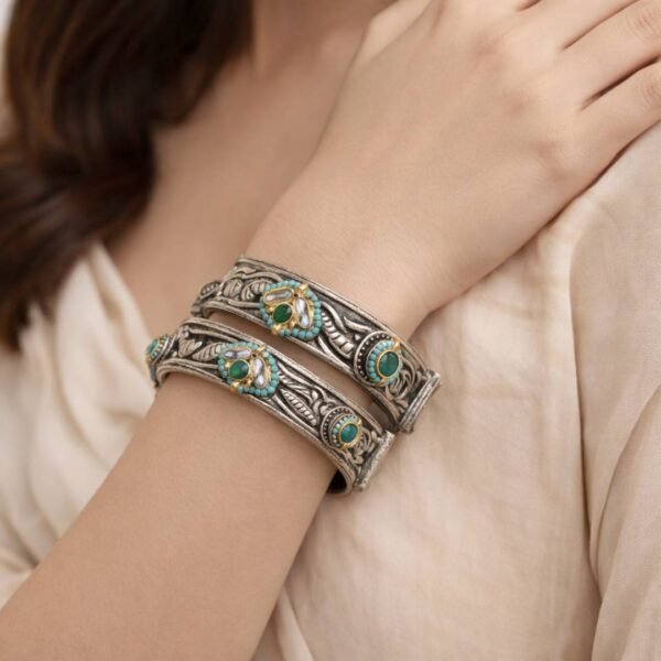 Two textured silver bangles with green and turquoise stones.