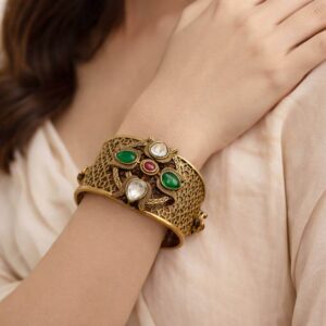 Large gold kada on a wrist.