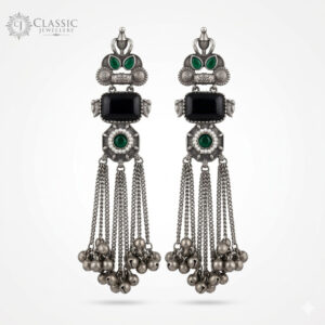 Handcrafted German silver long drop earrings with black stones and ruby accents featuring ghungroo tassels by Classicjewellery