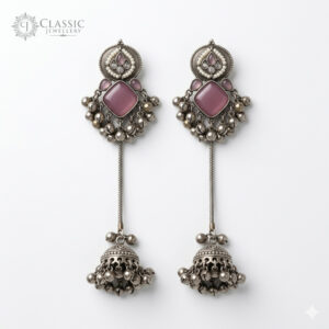 Long oxidized silver earrings with square pink stones and traditional jhumka drops.