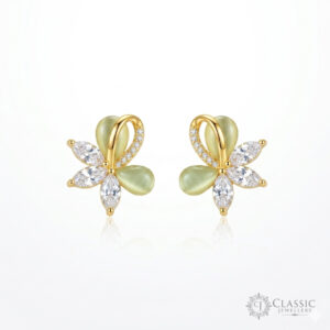 Gold-plated floral stud earrings with light green cat’s eye stones and sparkling crystals.