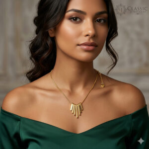 A high-polish gold necklace featuring a central fanned arrangement of five graduated geometric bar pendants.