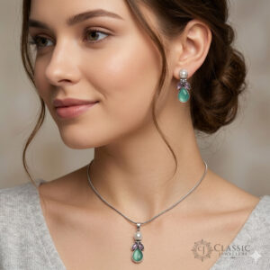 Elegant silver pendant necklace and matching earrings featuring green and purple antique-colored teardrop stones and pearls by Classicjewellery