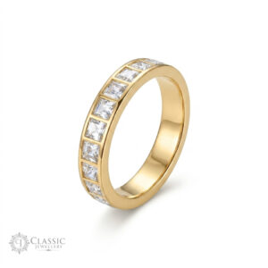 A detailed view of a polished gold plated anti turnish ring, densely set with princess-cut cubic zirconia stones in a channel setting.