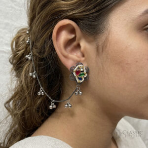 Model wearing German silver flower studs with multi-color stones and a ghungroo hair chain by Classicjewellery