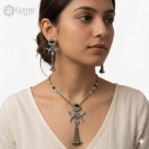 Model wear Handcrafted oxidized silver jewelry set featuring a peacock motif pendant with ghungroo tassels and matching drop earrings on a white background.