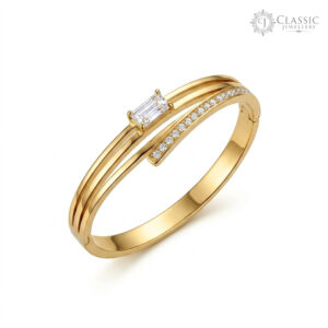 Minimalist gold plated kada featuring a center baguette solitaire and crystal accents by Classicjewellery