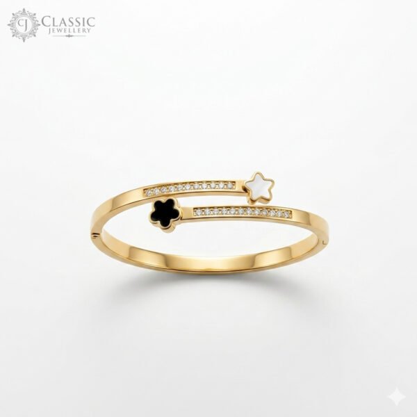 Gold-plated bypass bangle featuring a white shell star, a black onyx-style clover, and crystal-studded accents.