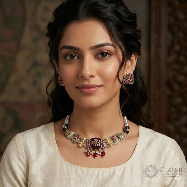 A detailed Indian heritage-style choker featuring deep ruby stones, intricate gold and silver metalwork, and delicate pearl drops, shown on a model.