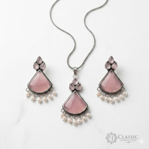 silver necklace and earrings set with rose pink stones and pearl droplets by Classicjewellery