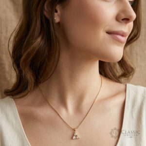 Model wearing a dainty gold triangle pendant necklace with anti-tarnish finish by Classicjewellery