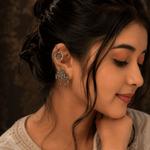 Woman wearing german silver peacock earcuff with floral upper clip