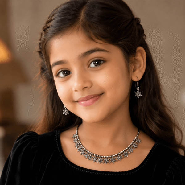 Young girl wearing silver floral necklace with matching dangling earrings