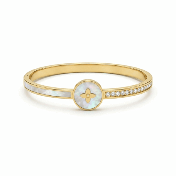 A slim, polished gold hinged kada featuring a central round medallion with an iridescent mother of pearl inlay and a gold four-petal floral monogram, flanked by a smooth mother-of-pearl band on one shoulder and a row of pave diamonds on the other.