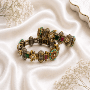 Antique gold finish kada bangles with multicolor stones, kundan detailing, and turquoise bead accents displayed on white satin fabric.
