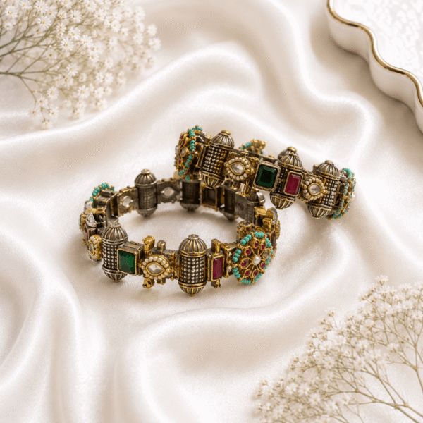 Antique gold finish kada bangles with multicolor stones, kundan detailing, and turquoise bead accents displayed on white satin fabric.