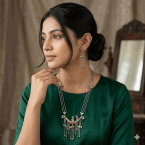 A woman wearing a handcrafted, multi-layered silver-toned necklace featuring boat and fish motifs with colorful accents, paired with matching drop earrings.