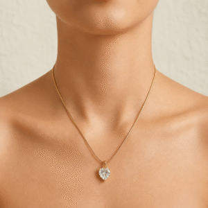 Woman wearing a gold-plated stainless steel necklace with a sparkling heart-shaped crystal pendant, ideal for daily wear and gifting.