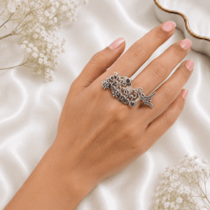 floral detailing, and purple stone accents on a soft cream satin background.