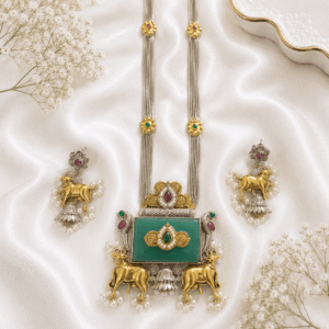 silver and gold tone cow motif statement necklace with green stone and matching earrings for women