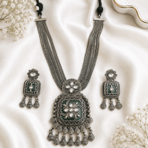 Premium German silver green necklace set with matching earrings featuring white Kundan stones in an antique german finish.