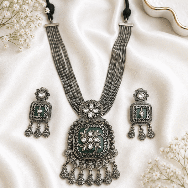 Premium German silver green necklace set with matching earrings featuring white Kundan stones in an antique german finish.