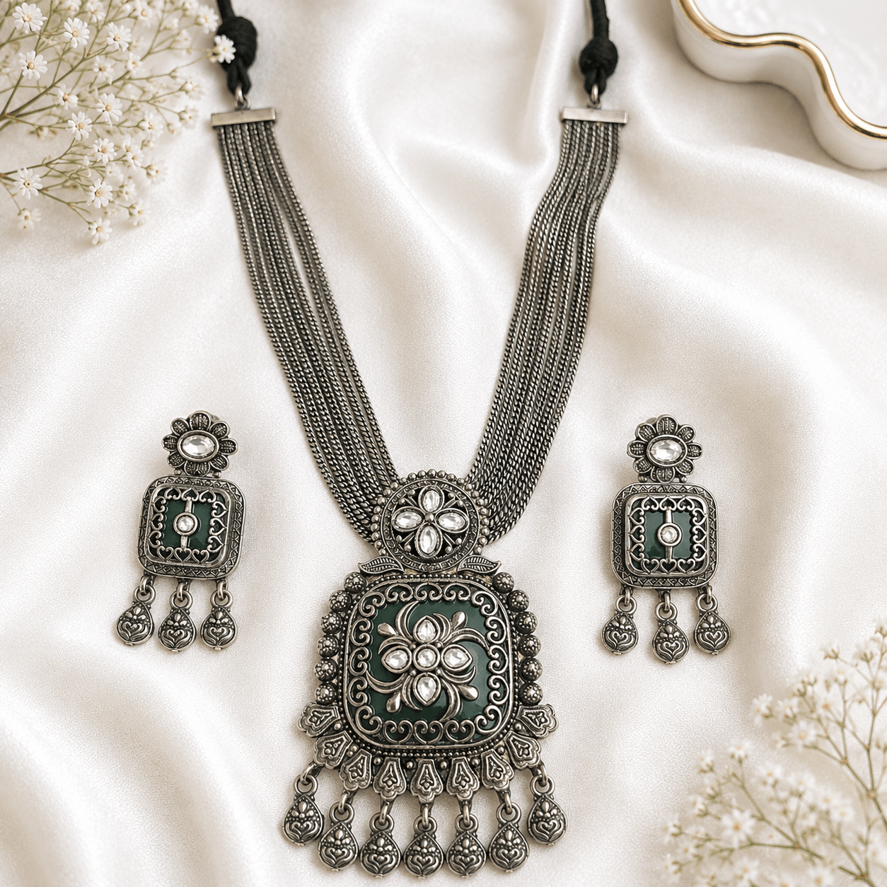 Premium German silver green necklace set with matching earrings featuring white Kundan stones in an antique german finish.