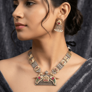 the necklace features a beautifully designed peacock-inspired pendant embellished with vibrant pink and green stones.