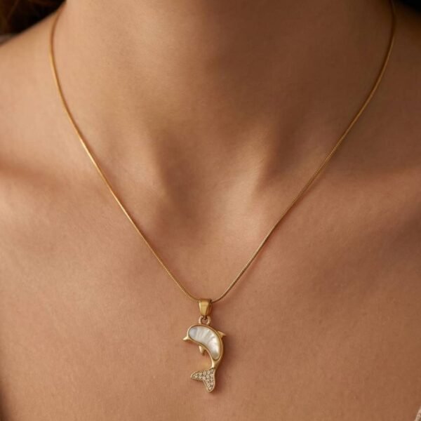 Elegant gold-plated dolphin pendant necklace featuring a white enamel finish on a delicate chain for women.
