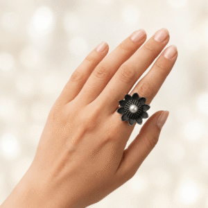 Black oxidised flower design ring with pearl center worn on hand