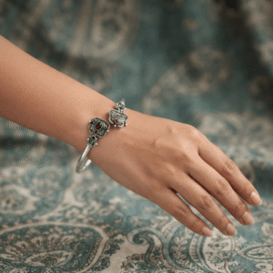 Woman wearing an oxidised German silver open cuff kada and traditional ethnic design.