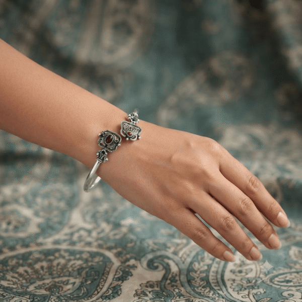 Woman wearing an oxidised German silver open cuff kada and traditional ethnic design.