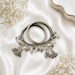 Traditional oxidized silver pearl bangles pair with white pearl beads and ghungroo charms for women.