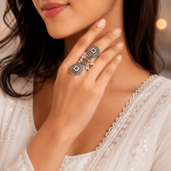 silver adjustable statement finger ring with pearl chain and ruby stone for women