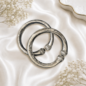 Pair of traditional silver anklet kadas with antique tribal engraved design for women, designed to be worn on the ankles.