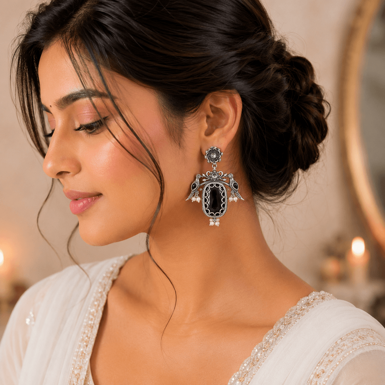 Woman wearing vintage oxidized German silver black stone bird dangler earrings with floral stud design and pearl accents.