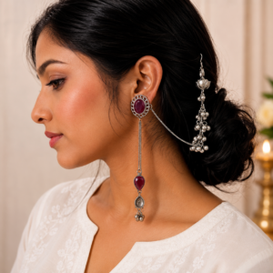 Woman wearing premium German silver long chain earrings with mint red stone and ghungroo detailing.