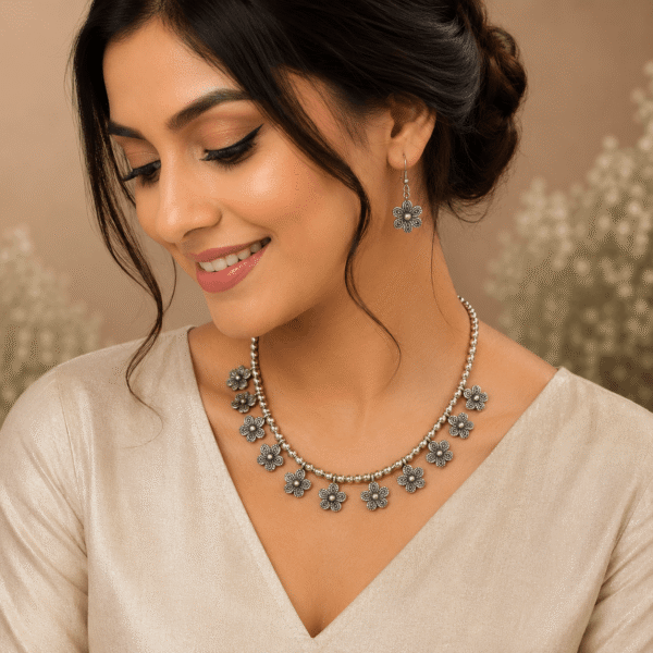 Young girl wearing leaf design silver necklace with matching leaf earrings