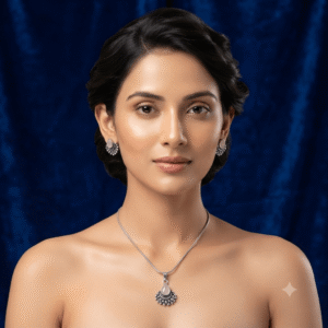 A young woman wearing a traditional silver necklace and earring set featuring white stone gajara style design