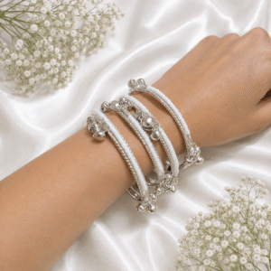 silver multi-strand bracelet with white beads and traditional floral detailing