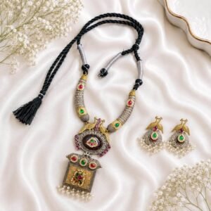 long necklace with peacock design, multicolor green and pink stones, black thread and matching earrings