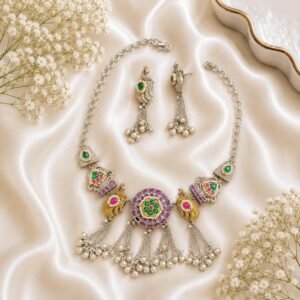 silver necklace and matching peacock earrings with green and pink stones and pearl bead detailing