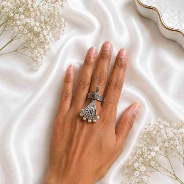 silver statement ring with a fan-shaped design and pearl embellishments