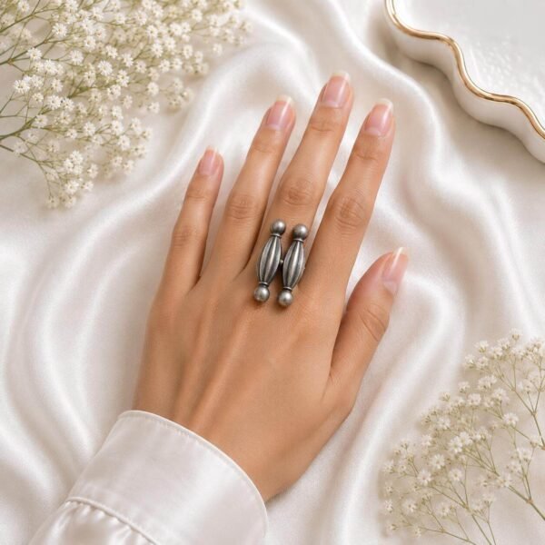 silver double-loop statement ring with elongated textured design