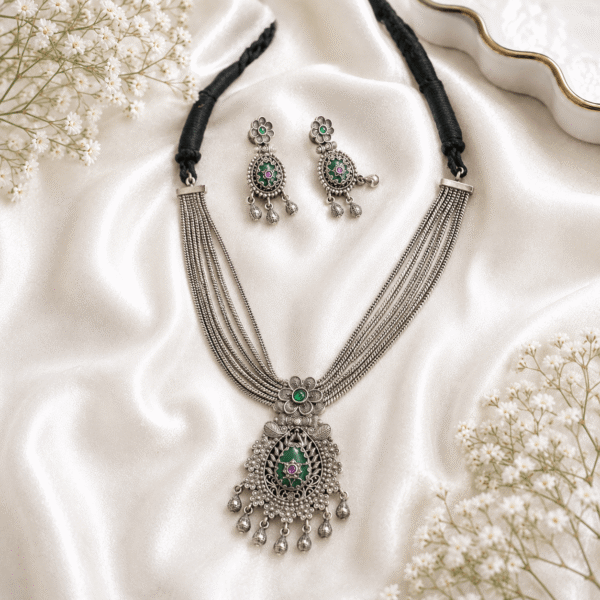 silver multi-layer necklace with green and pink stones and matching earrings