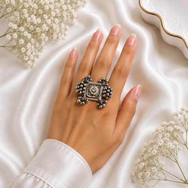 silver square statement ring with intricate floral centre and beaded detailing